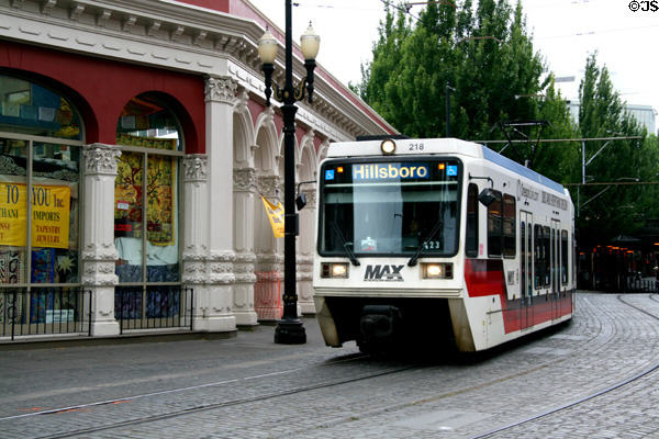 Portland's Metropolitan Area Express (MAX) / TriMet LRT streetcar beside Ankeny Square cast-iron Colonnade. Portland, OR.