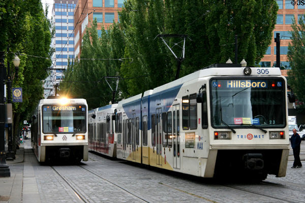 Two Portland streetcars pass. Portland, OR.