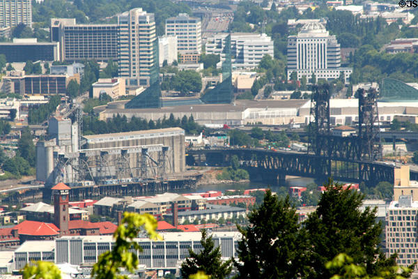 Skyline of Portland Convention Center, grain elevator, Union Station & North Steel Bridge over Willamette River. Portland, OR.