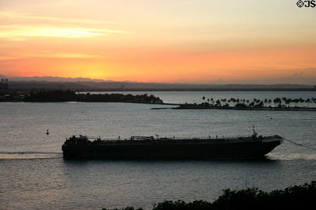 Barge in San Juan harbor channel at sunset. San Juan, PR.