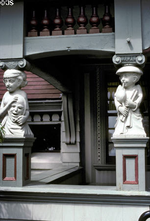 The Breakers Children's House porch columns carved figures of bagpiper & player with mask. Newport, RI.