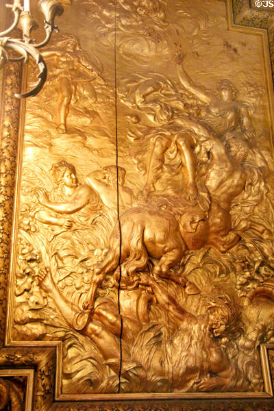 Gold panel with story of Hercules aiming an arrow at a centaur that has kidnapped his wife Deineira in Gold Room at Marble House. Newport, RI.