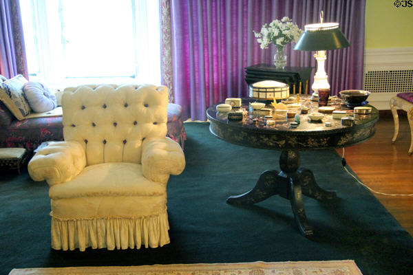 Doris Duke's bedroom with easy chair & round table inlaid with mother of pearl at Rough Point. Newport, RI.
