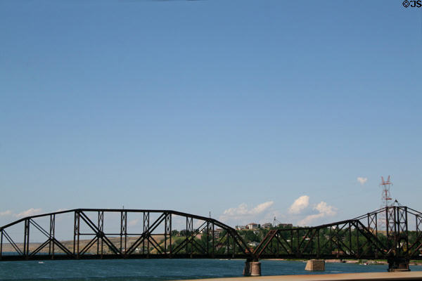 Chicago and North Western Railroad Bridge rail bridge across Missouri River with escarpment of Pierre beyond. Pierre, SD. On National Register.