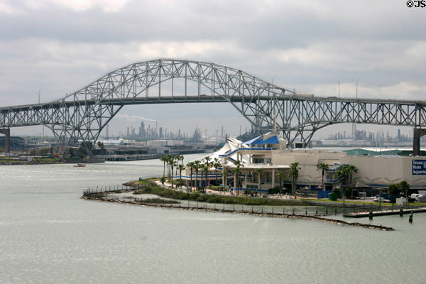 Texas State Aquarium beside bridge over bay with refineries in distance. Corpus Christi, TX.