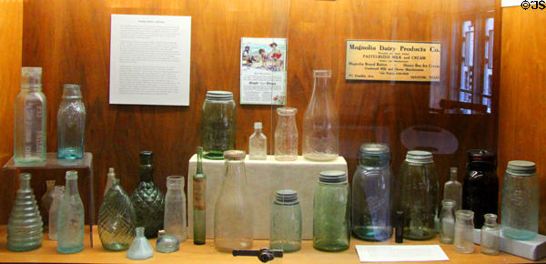 Collection of antique food bottles in lobby at Houston City Hall. Houston, TX.