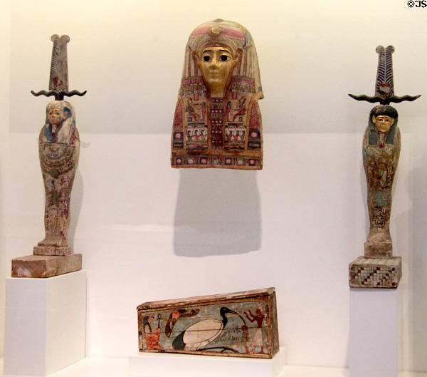 Egyptian mummy mask (c305 BCE-100 CE) with companion statues (300-30 BCE) & coffin painted with sacred ibis of Thoth (305-30 BCE) at Museum of Fine Arts, Houston. Houston, TX.