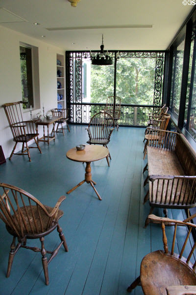 Glazed porch with collection of early Windsor chairs & benches at Bayou Bend. Houston, TX.