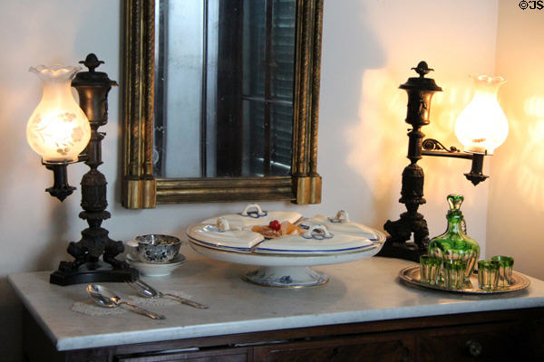 Argand lamps & serving dishes on sideboard at Nichols-Rice-Cherry House at Sam Houston Park. Houston, TX.