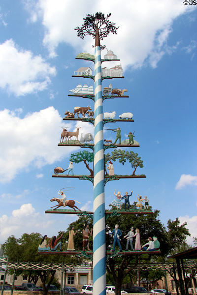 Maypole in Vereins Kirche park shows scenes related to history of Fredericksburg. Fredericksburg, TX.