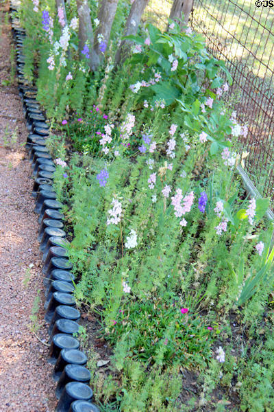 Pathway & flower bed edged by old bottles at Sauer-Beckmann Farmstead. Stonewall, TX.