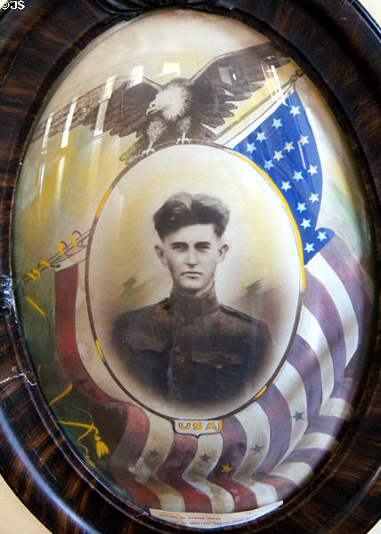 Picture of U.S. Soldier from WWI framed by eagle & American flag at Capt. Charles Schreiner Mansion. Kerrville, TX.