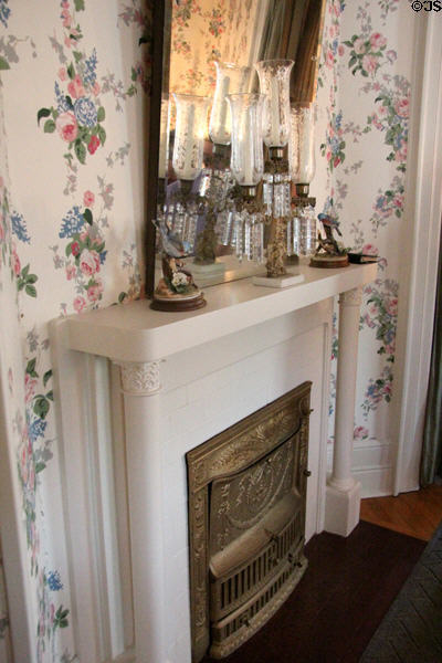 Fireplace in bedroom with floral wallpaper at McFaddin-Ward House. Beaumont, TX.