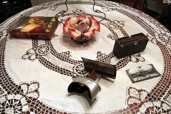 Parlor table with stereopticon plus glass bowl with shells at Fort House. Waco, TX.
