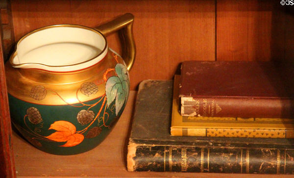 Gold & green pitcher with books at Fort House. Waco, TX.