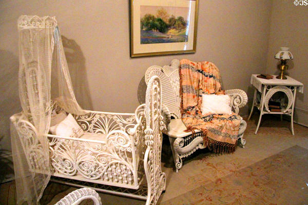 Victorian white wicker swing cradle, settee & side table at McCulloch House. Waco, TX.