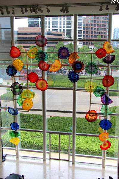 Glass composition by Dale Chihuly with view of city beyond at Dallas Museum of Art. Dallas, TX.