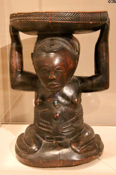 Wood stool supported by kneeling female figure (19th-20th C) by Luba culture of Democratic Republic of the Congo at Dallas Museum of Art. Dallas, TX.