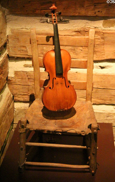 Side chair with rawhide seat (c mid 1800s) & fiddle (c late 1700s-early 1800s) (lent: private collections) at Bullock Texas State History Museum. Austin, TX.