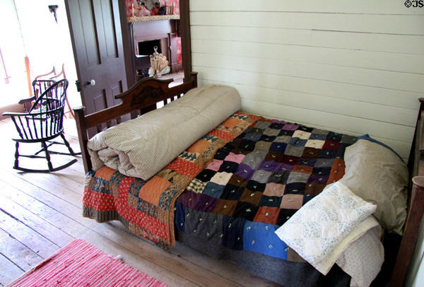 Bed with quilt in children's room in Bell House at Pioneer Farms. Austin, TX.
