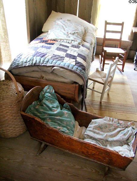 Children's bedroom with cradle in Frederick Jourdan cabin at Pioneer Farms. Austin, TX.