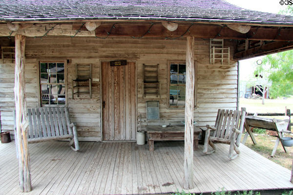 Gates house with rocking log furniture at Pioneer Village. Gonzales, TX.