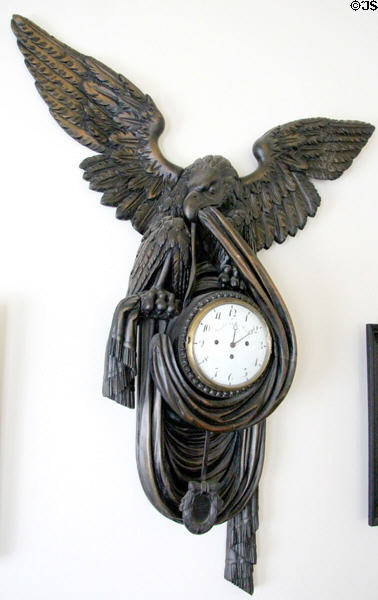 Carved eagle holding drapery framing clock at Museum of Texas Handmade Furniture. New Braunfels, TX.