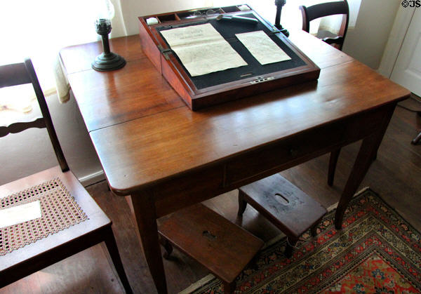 Walnut writing table with Biedermeier legs & children's foot stools below at Museum of Texas Handmade Furniture. New Braunfels, TX.