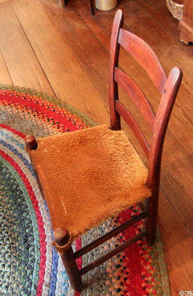"Mule ear" chair with cowhide seat at Museum of Texas Handmade Furniture. New Braunfels, TX.
