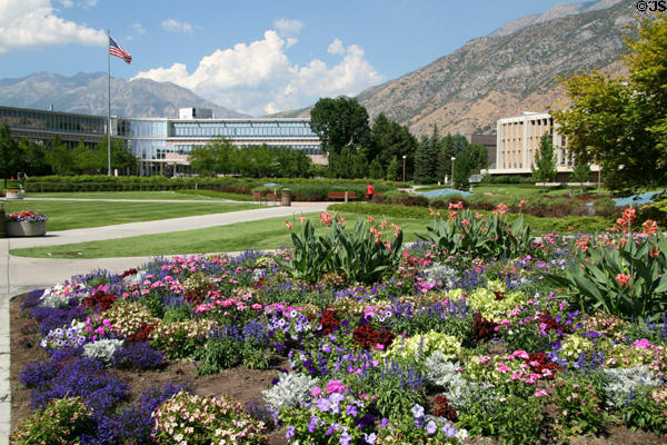 Flowers on central Quad of Brigham Young University with curved Abraham O. Smoot Administration Building (1961). Provo, UT.