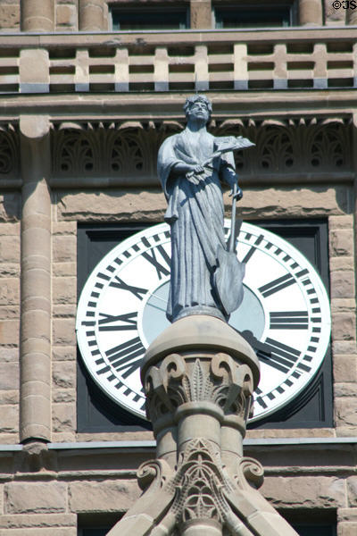 Statue of commerce in front of clock on tower of Salt Lake City & County Building. Salt Lake City, UT.