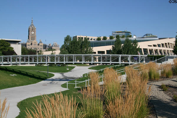 Footbridge across garden of Salt Lake Public Library with City Hall tower beyond. Salt Lake City, UT.