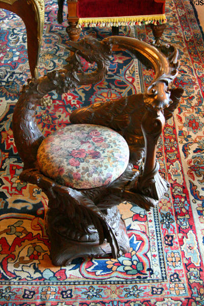 Carved wooden stool supported by wings of mythical bird at Maymont Mansion. Richmond, VA.