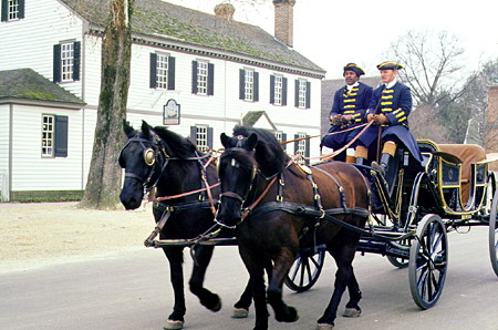 Horse drawn buggy passes John Greenhow house & store in Colonial Williamsburg. Williamsburg, VA.