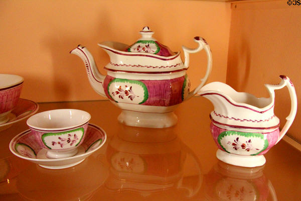 Pink lusterware tea set (c1830) from Staffordshire, England fired with metallic oxide pigments & popular until the invention of electroplating in 1840s at Shelburne Museum. Shelburne, VT.