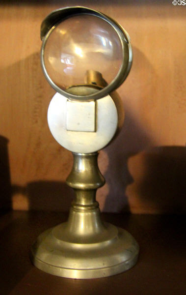 Candlestick with magnifying lens to concentrate light at Shelburne Museum. Shelburne, VT.