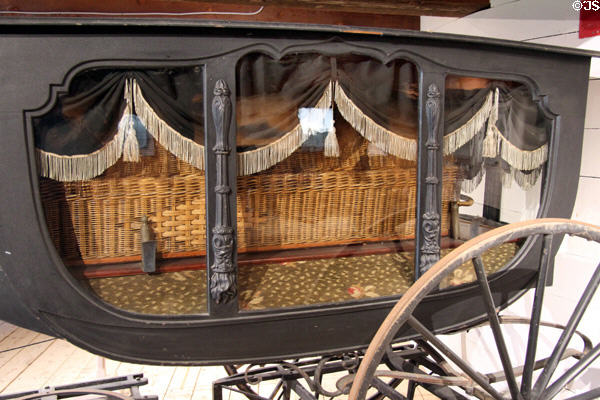 Window details of with symbolic inextinguishable eternal flames on hearse (c1849) by A. Tolman & Co. of Worcester, MA in Round Barn at Shelburne Museum. Shelburne, VT.