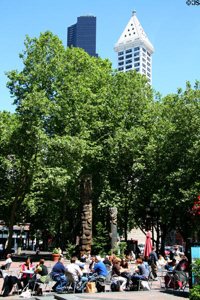 Sidewalk cafe in Occidental Park with Smith Tower & Columbia Center beyond. Seattle, WA.
