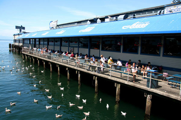 Patrons eating seafood at Ivars dock. Seattle, WA.