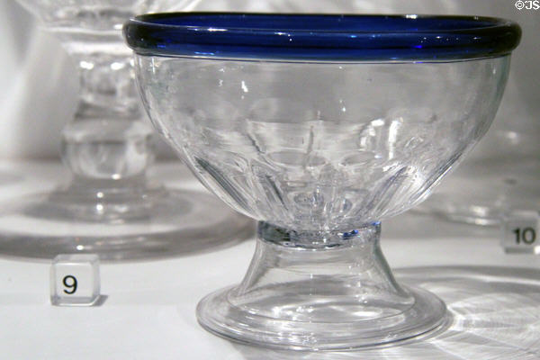 Footed blown lead glass bowl with cobalt blue applied glass lip (c1820-30) from Pittsburgh, PA in glass gallery at Huntington Museum of Art. Huntington, WV.