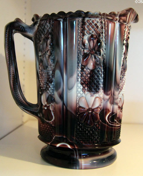 Pressed purple slag opaque soda lime glass water pitcher (1886) by Challinor Taylor & Co., Pittsburgh, PA at Huntington Museum of Art. Huntington, WV.