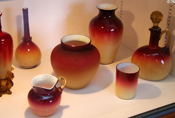 Group of red to amber shaded glass dishes (c1881-6) by Hobbs, Brockunier & Co., Wheeling, WV at Huntington Museum of Art. Huntington, WV.