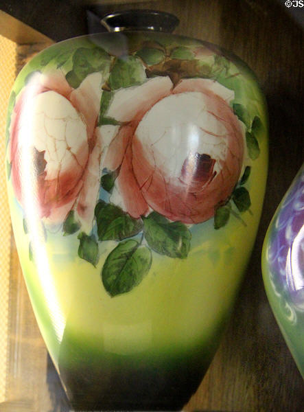 Milk glass vase with green to yellow color gradient & pink roses (1899-1904) at Fostoria Glass Museum. Moundsville, WV.