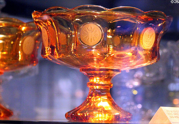 Coin glass footed compote in amber (1961-82) at Fostoria Glass Museum. Moundsville, WV.