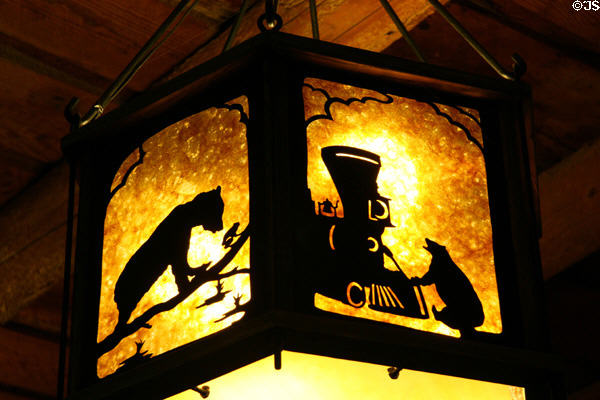 Old Faithful Lodge hanging lamp with bears & train at Yellowstone National Park. WY.