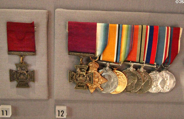 Victoria Cross medals with red ribbons plus others from WWI (1914-9) at Museum of Liverpool. Liverpool, England.