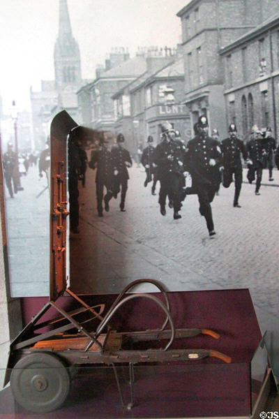 Gladstone Riot Shield (1929) by Robert Gladstone of Liverpool was armored to stop bullets with slits for viewing & firing back which could be folded down & wheeled for transport at Museum of Liverpool. Liverpool, England.