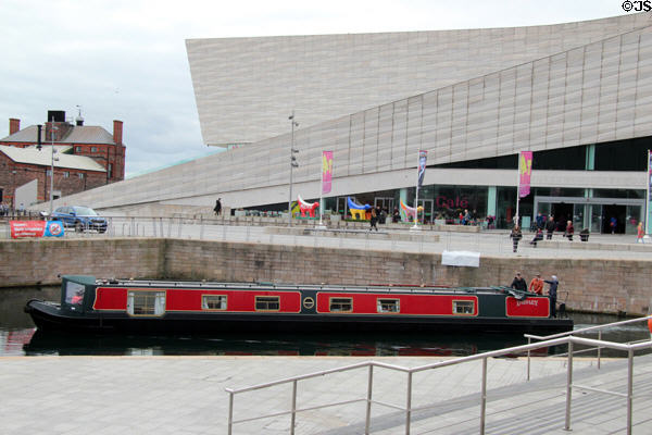 Canal boat passes Museum of Liverpool. Liverpool, England.