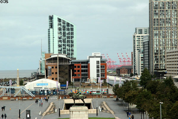 Liverpool cruise terminal complex north of Pier Head with residential & commercial highrises of Princess Port & cranes of container port in distance. Liverpool, England.