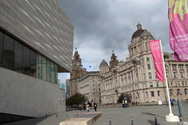 Three Graces of Pier Head face modern Museum of Liverpool. Liverpool, England.